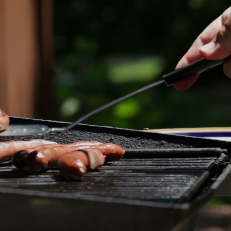 Grilling Hot Dogs outside home in Waco, TX.