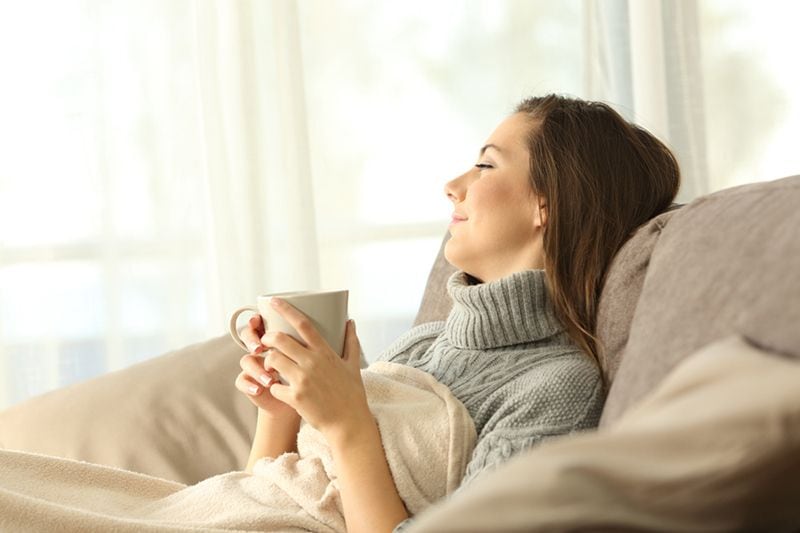 Image of person wrapped in a blanket and holding a cup. What Are Zone Control Systems?