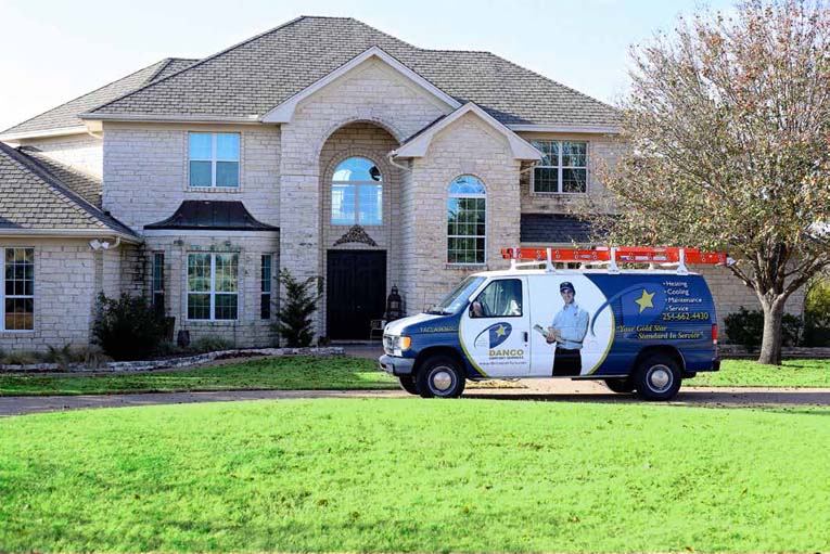 Danco Heating & Cooling service vehicle parked outside residential home in Waco, Texas.