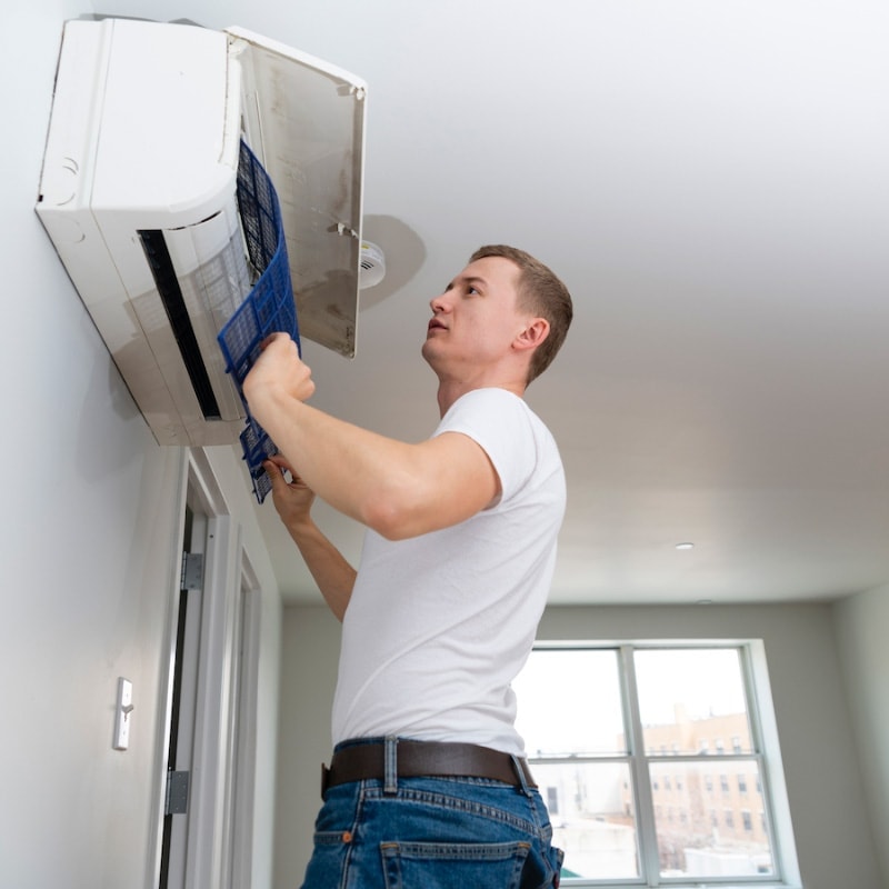 HVAC technician performing maintenance on a ductless mini split in Waco