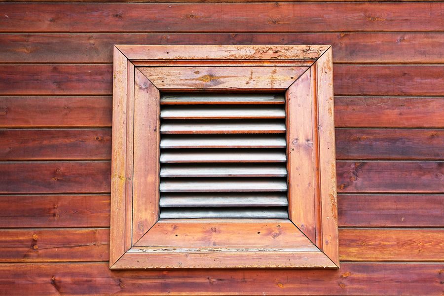 Vent with wooden casing on outside to represent what you should know about air handlers.